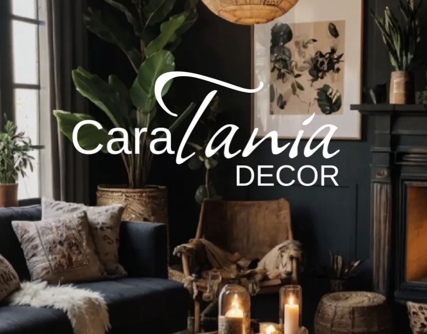 CaraTania Decor — a warm, layered living room with dark walls, natural textures, greenery, and candlelight